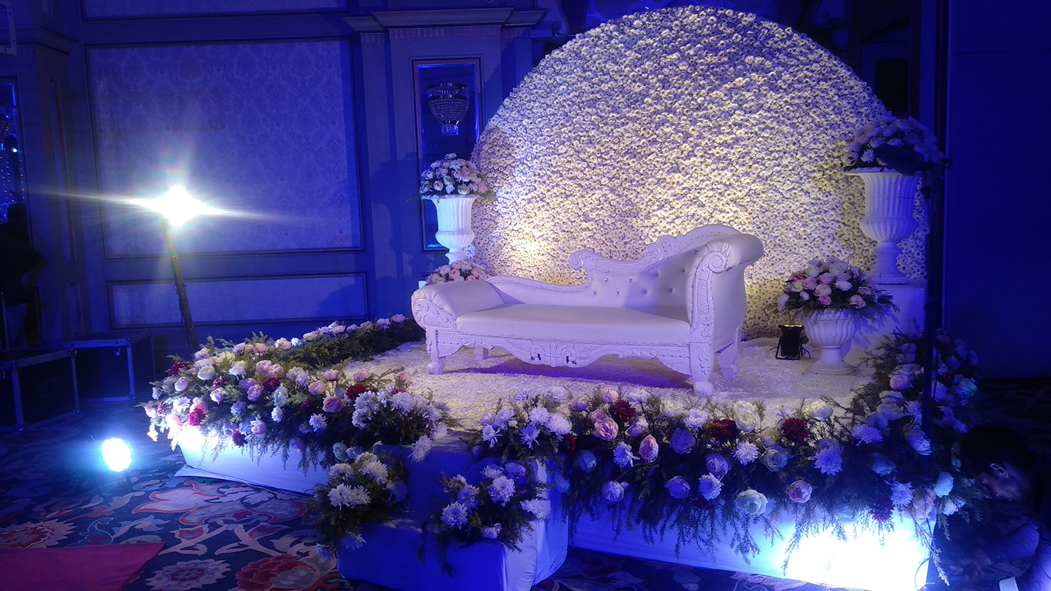 elegant-wedding-couches-and-enchanting-flower-decorations-with-blue-lights-1691682132
