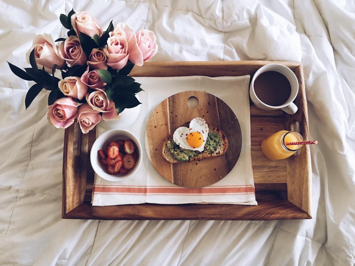 A wooden tray for breakfast in bed along with flowers and a heart shaped egg | Wedifys