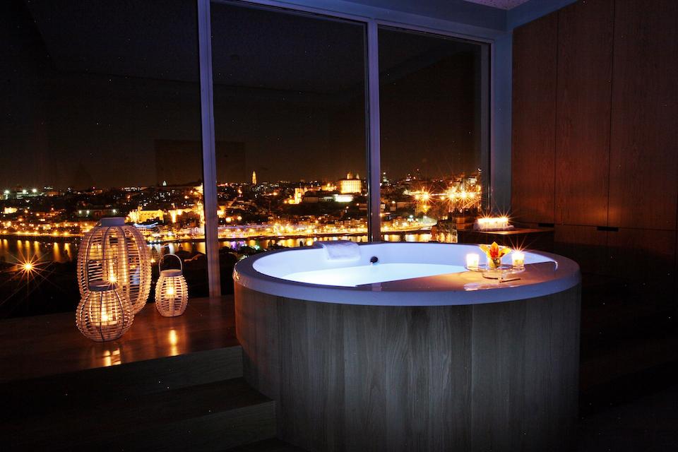 A Jacuzzi set with candles on side to give a pleasant vibe | Wedifys