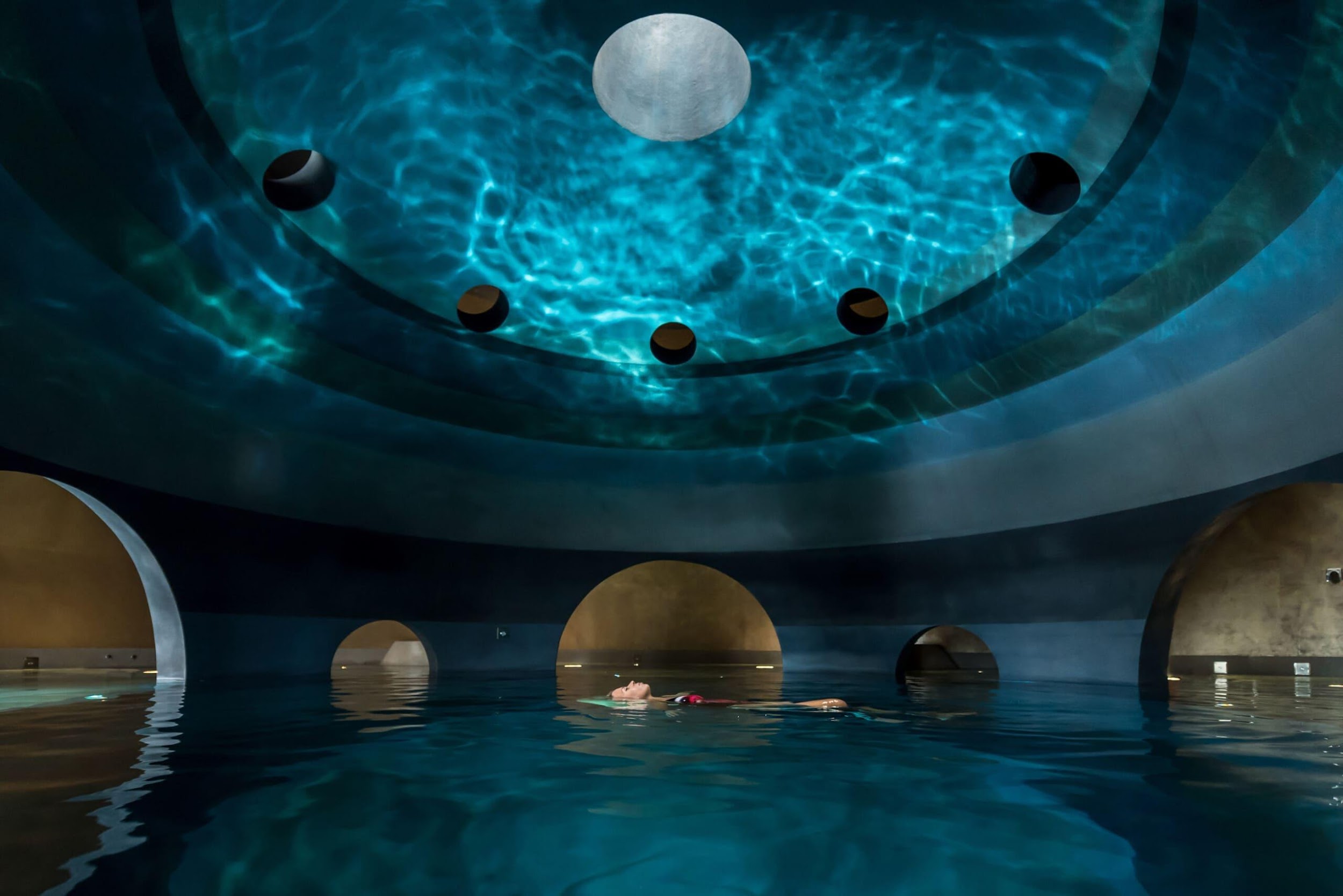 a woman floating on water in the spa | Wedifys
