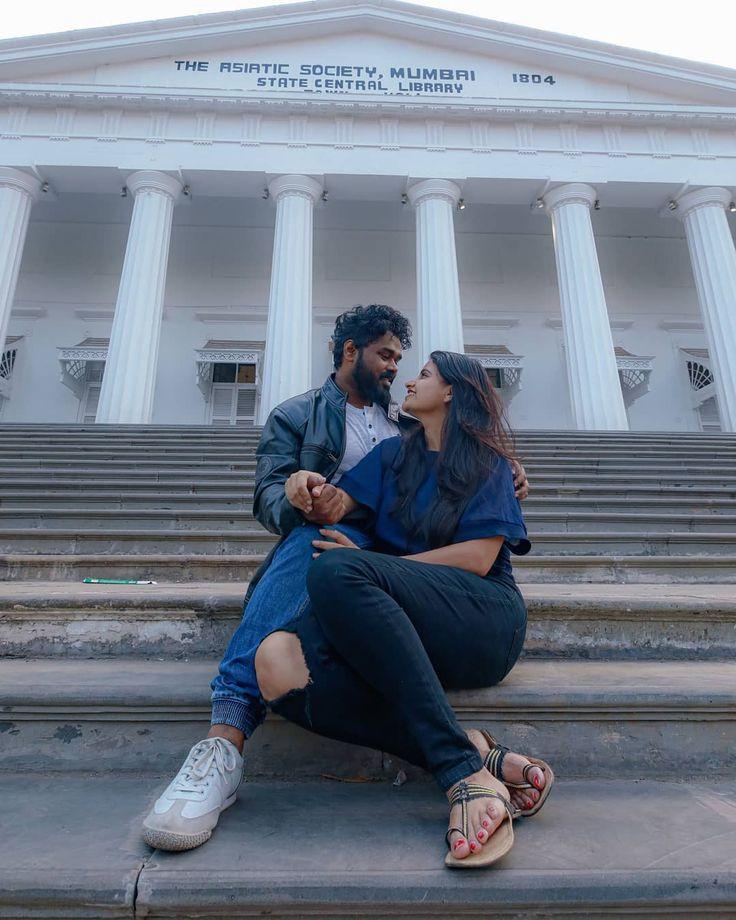 a couple sitting on the stairs of the Asiatic Library for their pre-wedding photoshoot | Wedifys