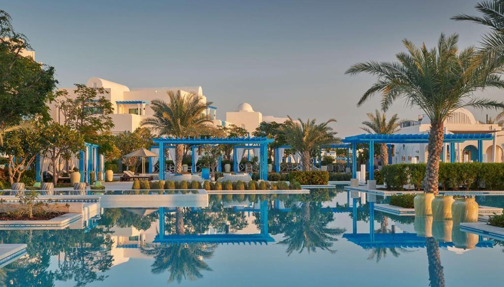 the well decorated swimming pool of the Hilton Salwa Beach Resort | Wedifys