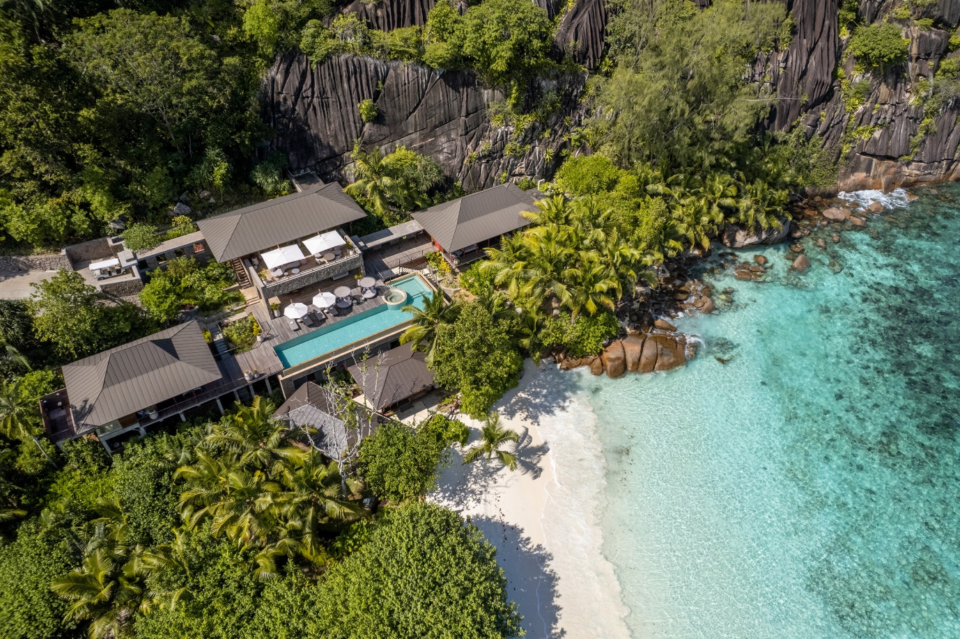 The four seasons resort in Seychelles in the trees besides the sea | Wedifys