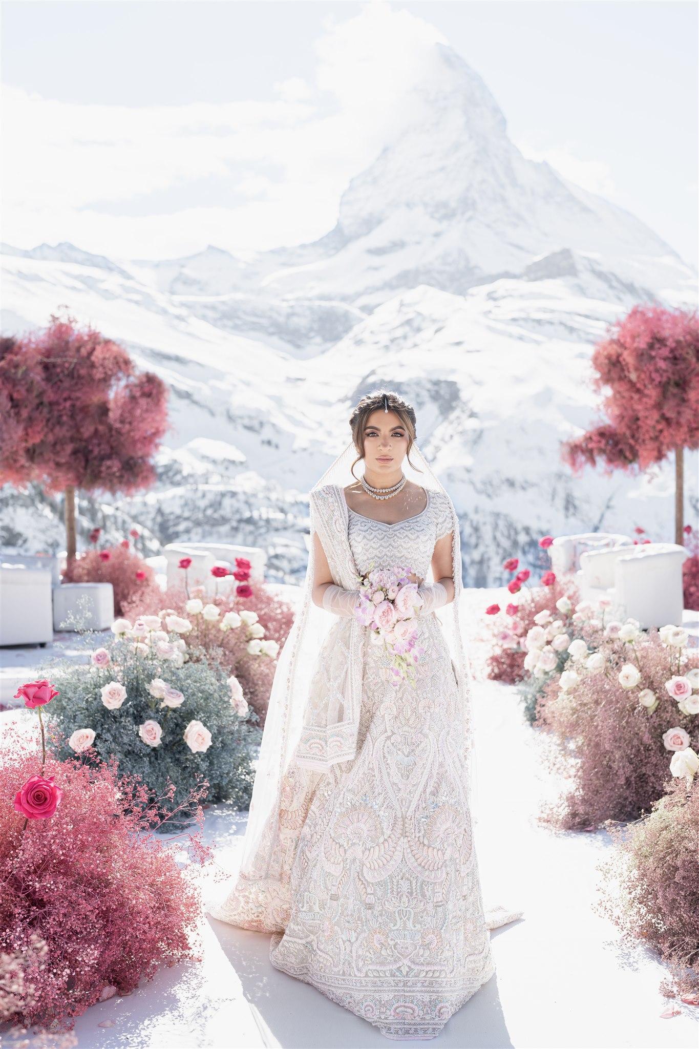 Sonam in her modern-cultural wedding dress walking down the aisle while holding a flower bouquet | Wedifys