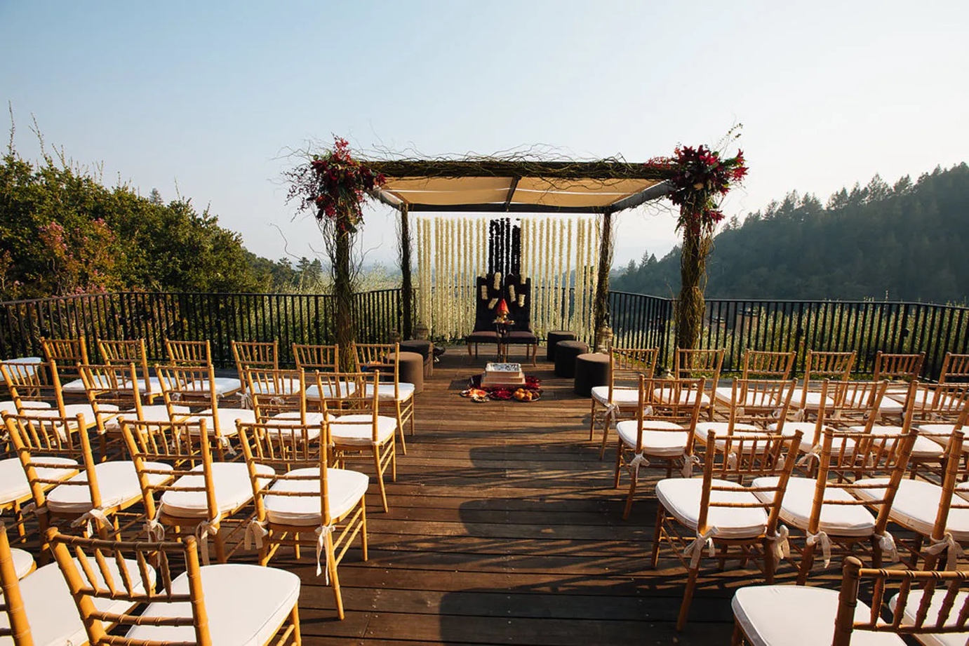 mandap set in nature with rustic-glam branches and wild red blooms | Wedifys