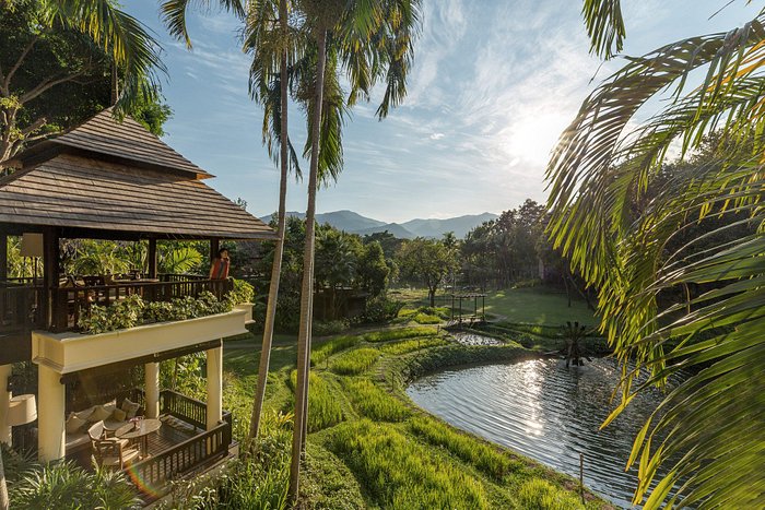 a woman standing in the balcony of the Four Seasons Resort in Chiang Mai | Wedifys
