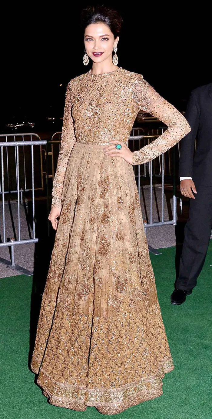 gold floor-length frock embellished with stones | Wedifys