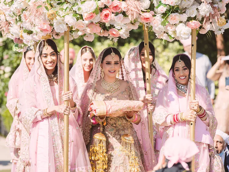 Indian bride accompanied by her bridesmaids | Wedifys