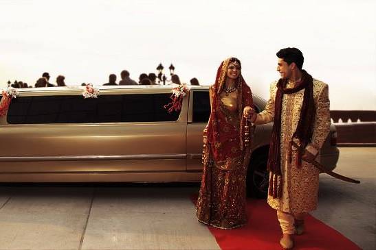 Indian bride and groom getting out of a luxury car | Wedifys