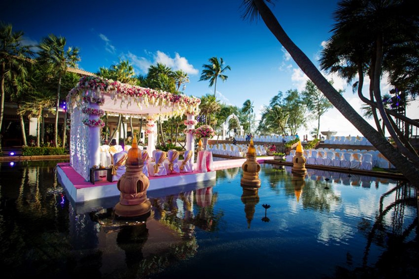 a setup of a traditional Indian wedding in Thailand surrounded by water | Wedifys