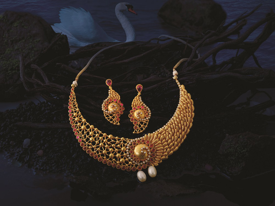 gold necklace by Reliace Jewels adorned with pearls and red stones | Wedifys