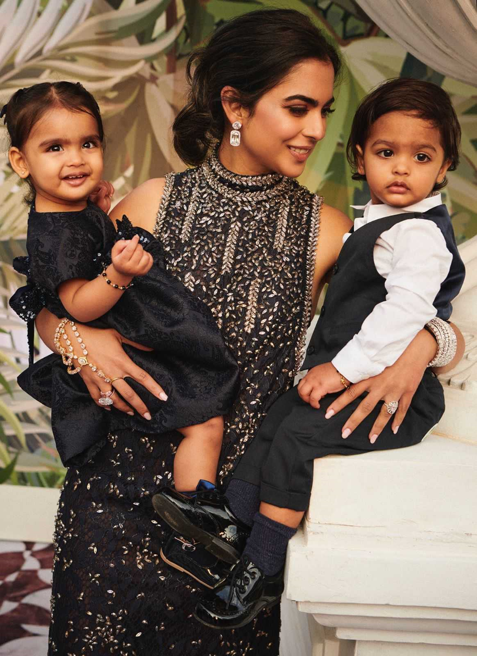 Isha can be seen posing with her twins Aadiya and Krishna in her arms at the pre-wedding gala of Anant Ambani and Radhika Merchant in Jamnagar.