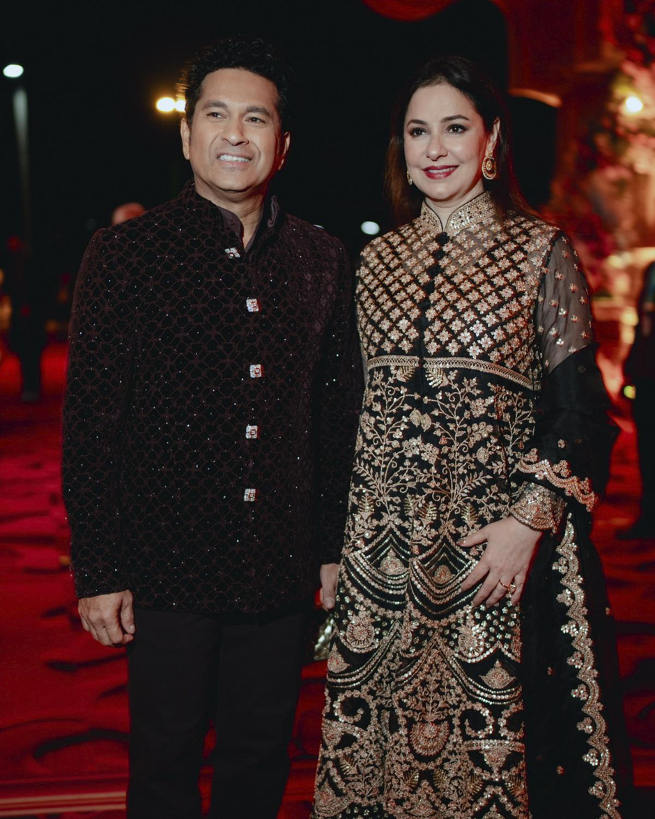 This photograph released by the Reliance group shows Indian cricketer Sachin Tendulkar posing for a photograph with his wife Anjali at a pre-wedding bash of billionaire industrialist Mukesh Ambani’s son Anant Ambani in Jamnagar, India | Wedifys