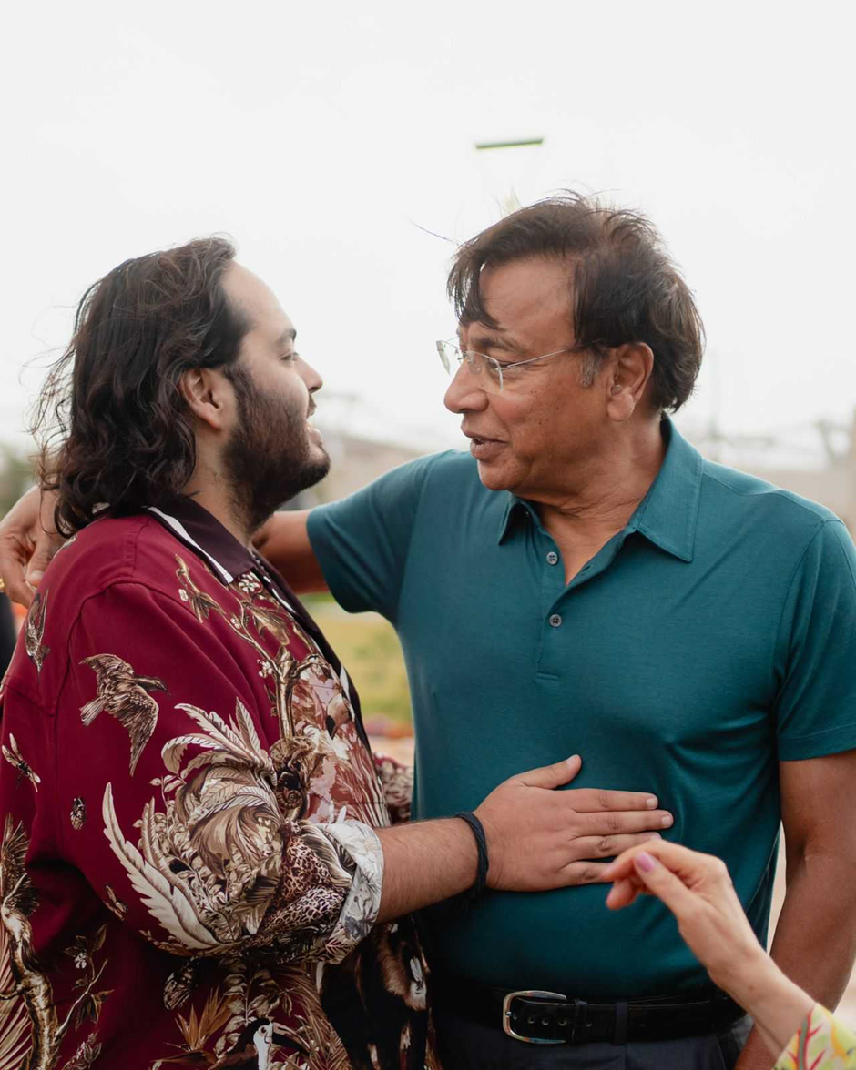 Groom-to-be Anant in a maroon printed shirt hugging Lakshmi Mittal, the chairman of ArcelorMittal, at the pre-wedding gala of Anant Ambani and Radhika Merchant in Jamnagar.