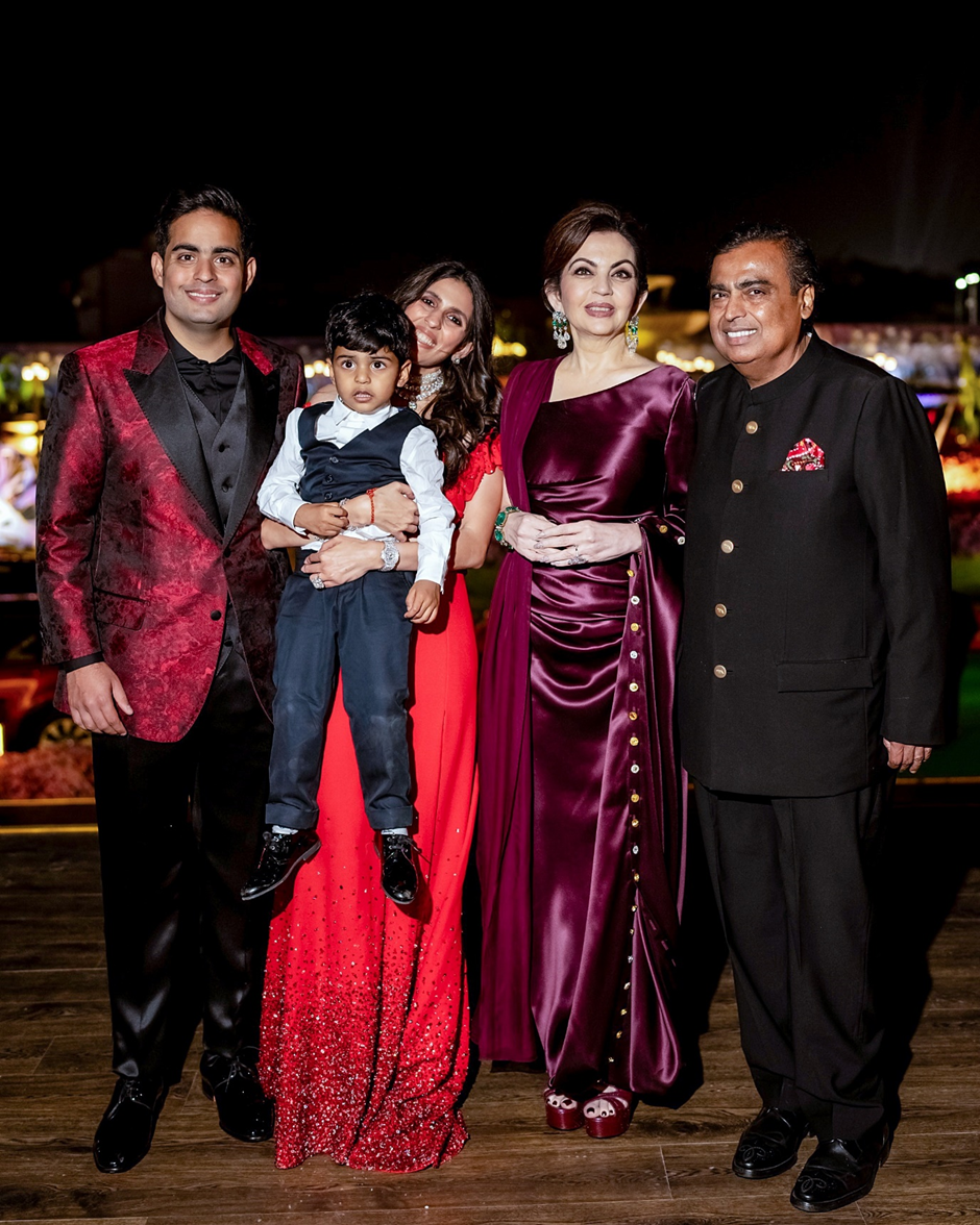 Mukesh Ambani and his wife Nita Ambani pose with their eldest son Akash Ambani, daughter-in-law Shloka Mehta, and grandson Prithvi Ambani during the pre-wedding celebrations in Jamnagar on March1.