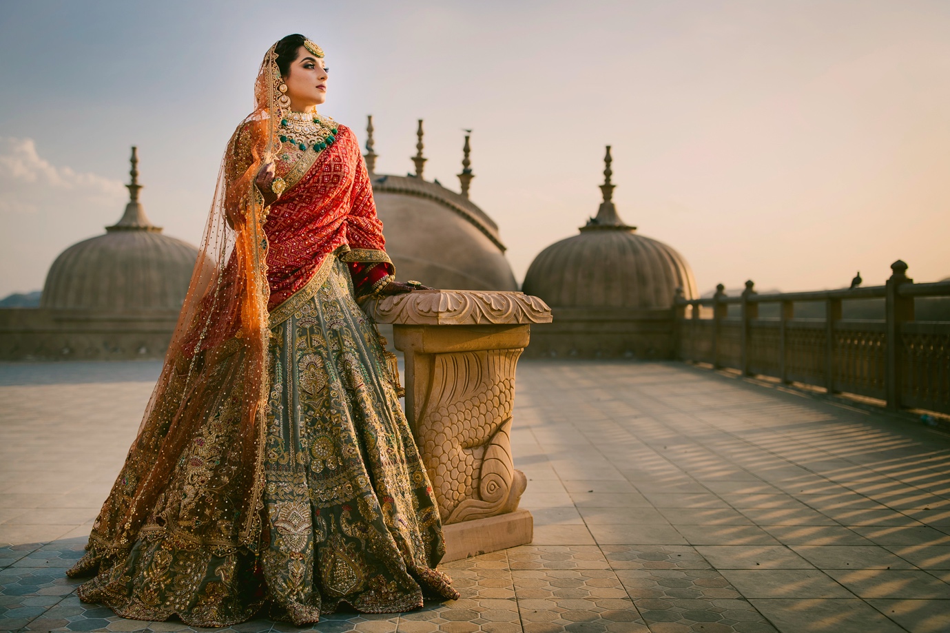 Indian bride posing at the top of a historic site | Wedifys