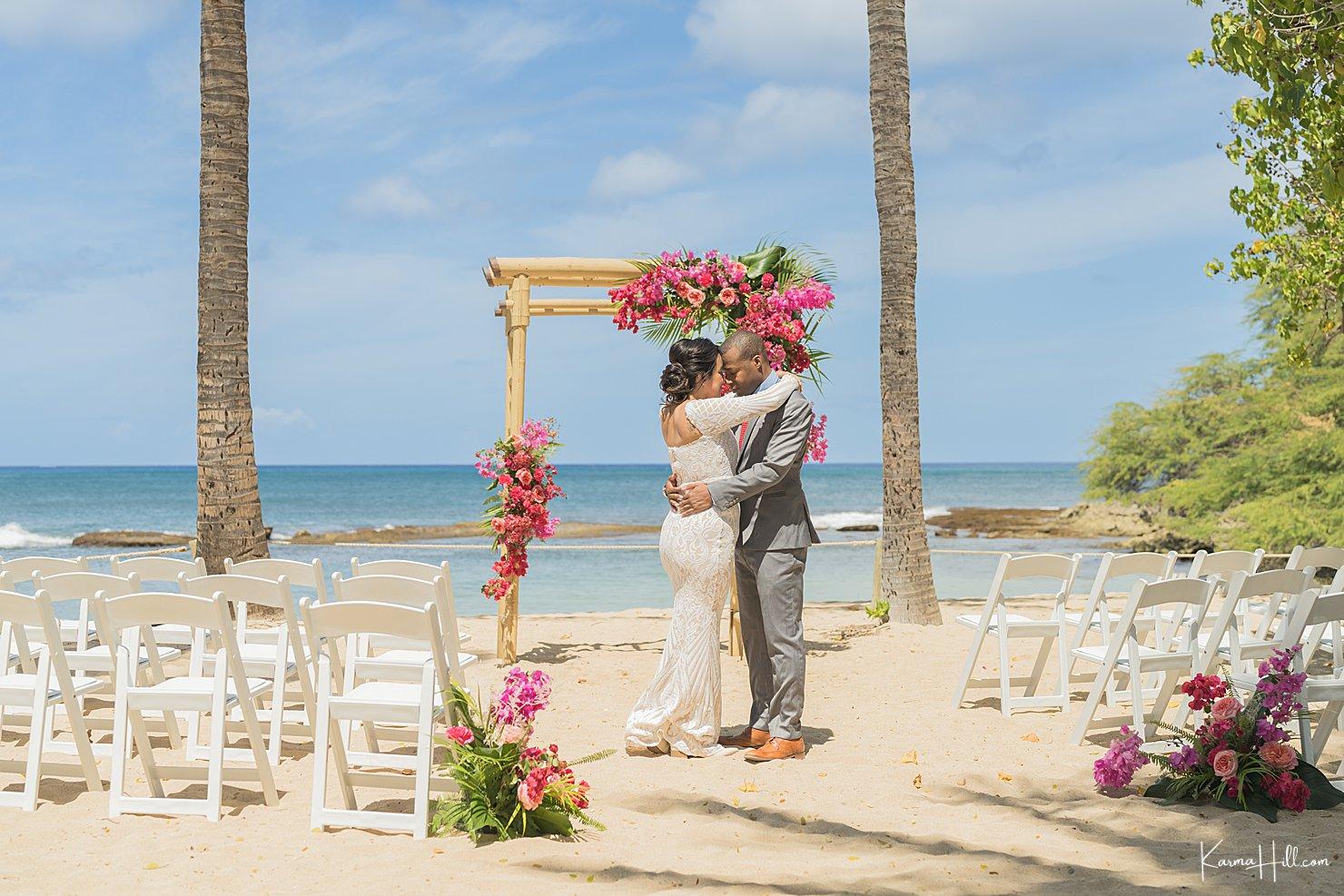 a couple in their wedding photoshoot on a beach in Hawaii | Wedifys