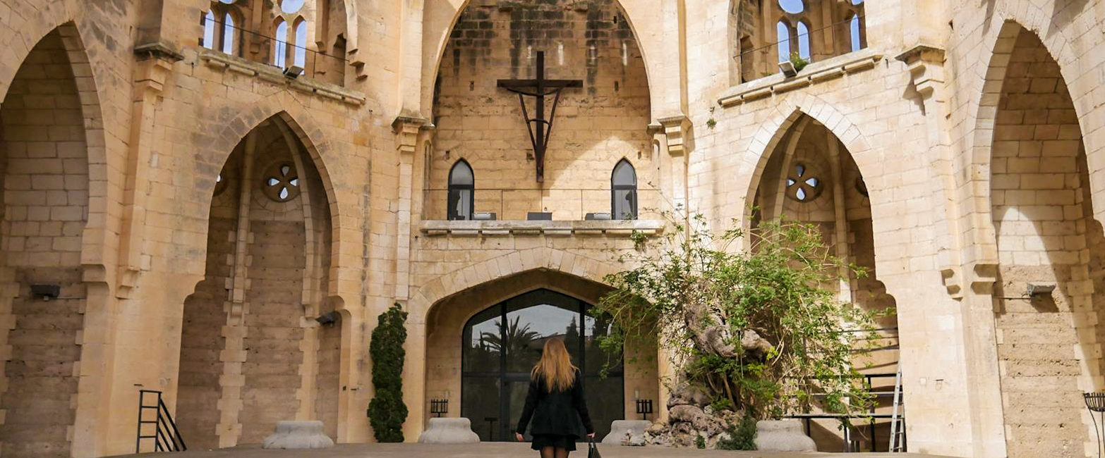 a woman walking towards a church in Son Servera, Mallorca, Spain | Wedifys