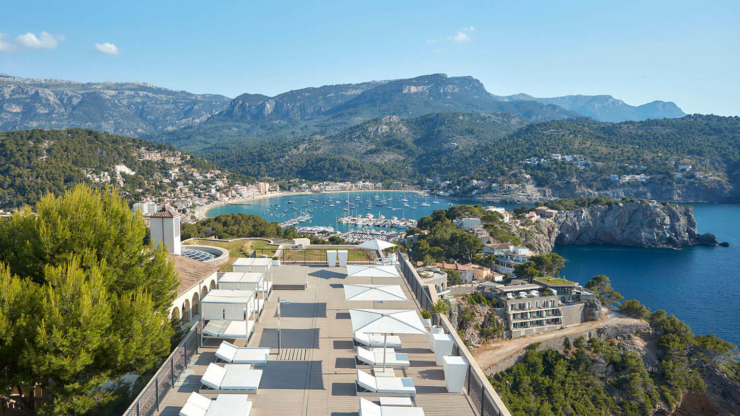 a view of the Jumeirah Port Soller Hotel & Spa with the Serra de Tramuntana mountains in the background | Wedifys