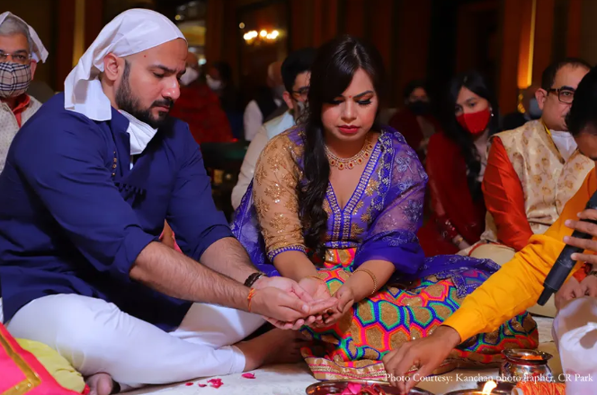 Shristi and Kartik performing the traditional Mata ki Chowki | Wedifys