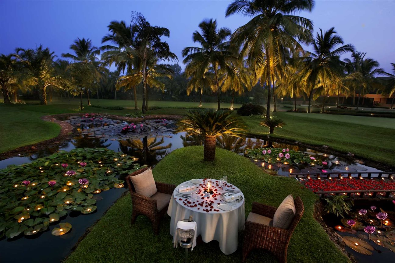 a dining table in the gardens of The Leela, Goa | Wedifys